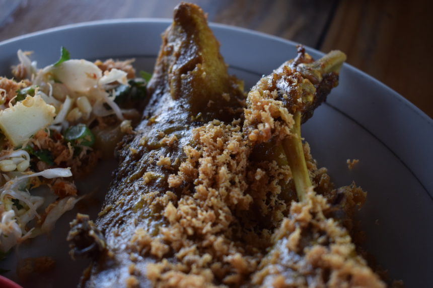 close-up of kremes on top of bebek goreng