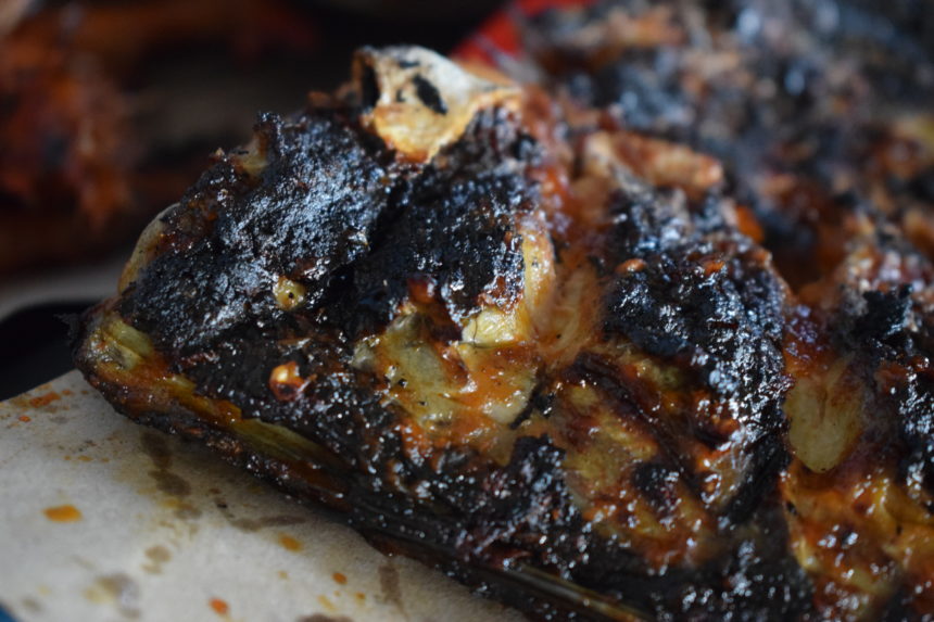 close-up of barracuda showing glazed sauce and charcoal char