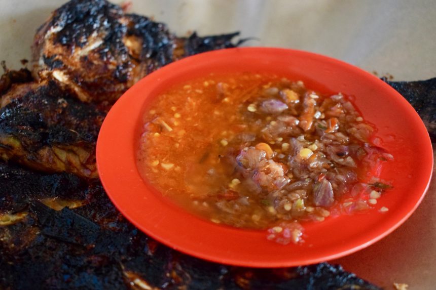 Red bowl I was served at Jimbaran fish market containing sambal matah and sambal terasi