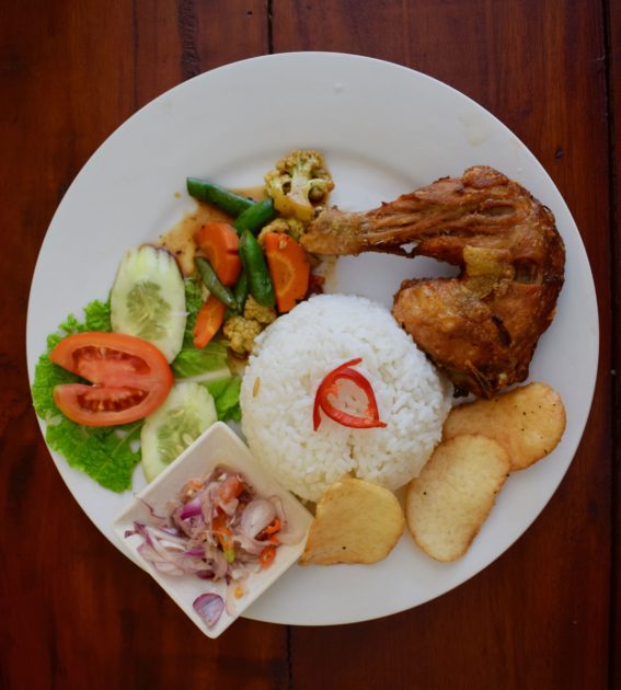 Plate of chicken lalapan and cracker with nasih putih and a small dish of sambal matah from Bali