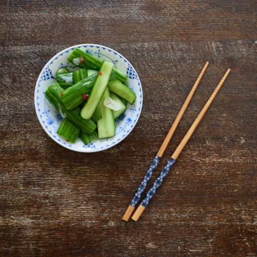 Taiwanese cucumber salad on table with chopsticks