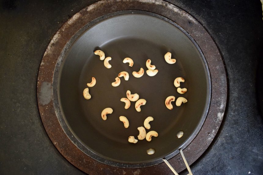 Toasting golden brown cashew nuts in a hot pan