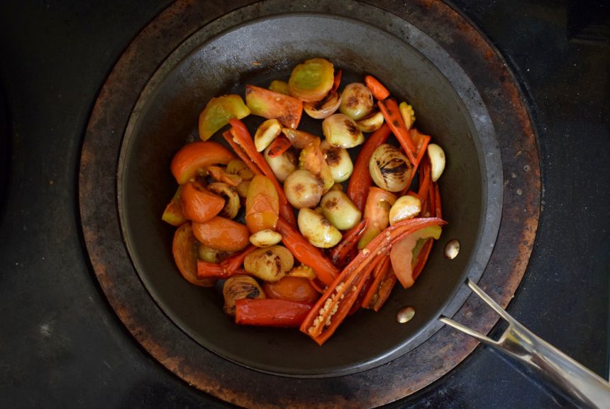 Frying the chillies shallots garlic and tomatoes until they are blackened and soft