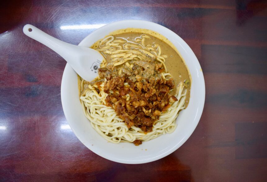 My verdict of what to eat in Taitung - a bowl of Taiwanese sesame noodles with spoon half submerged in thick Chinese sesame sauce