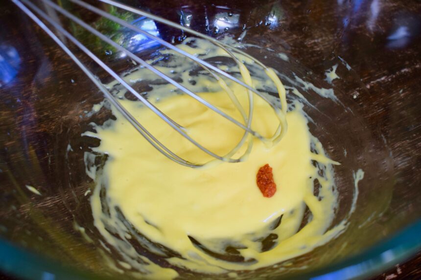 Mixing nduja paste into a bowl of homemade mayonnaise