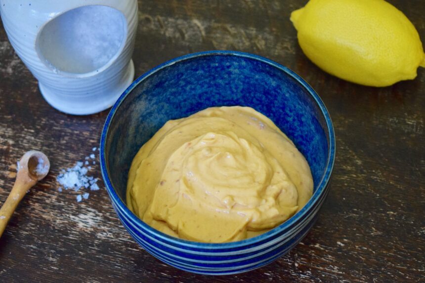 Homemade nduja mayo recipe with lemon and flaked salt in the background