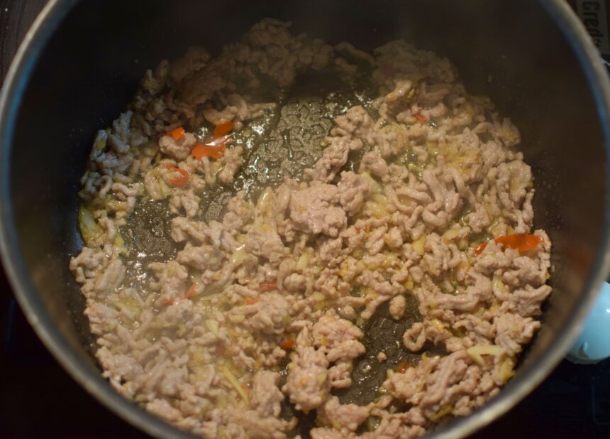 Pork mince for Thai basil minced pork cooked in a wide pan until it has just turned opaque